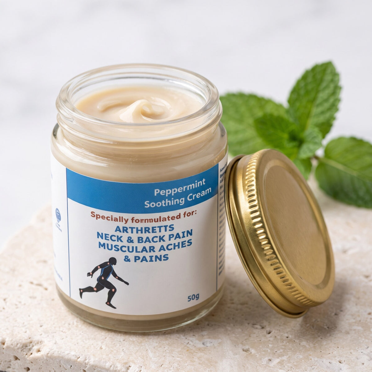 Peppermint Soothing Cream open jar showing the cream texture, gold lid beside it